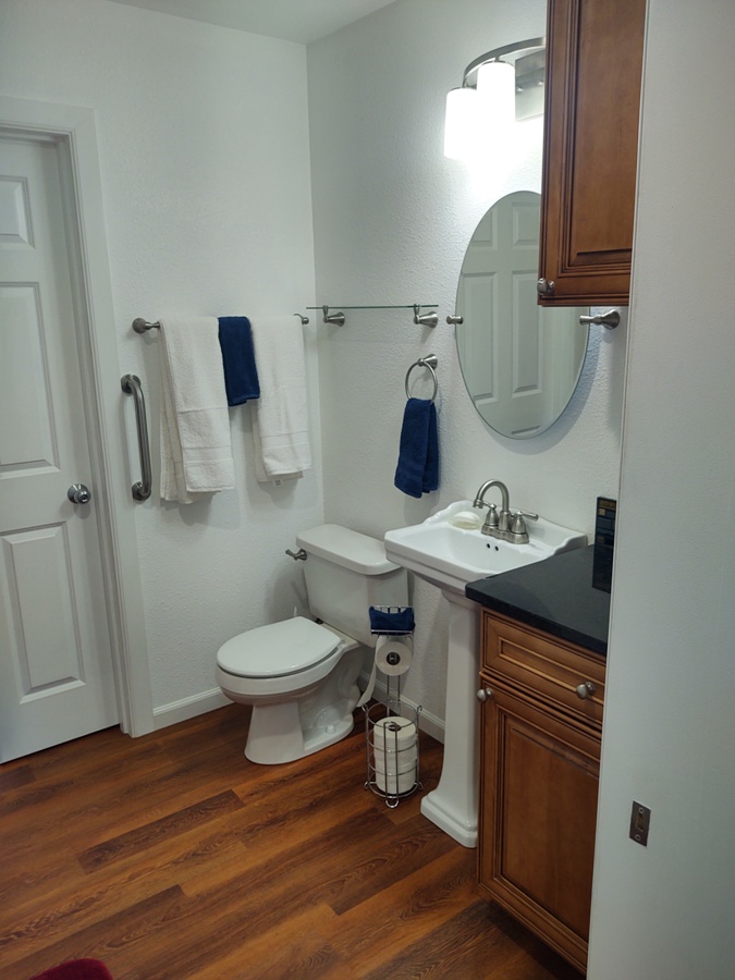 New bathroom fixtures & ADA grab bar next to toilet