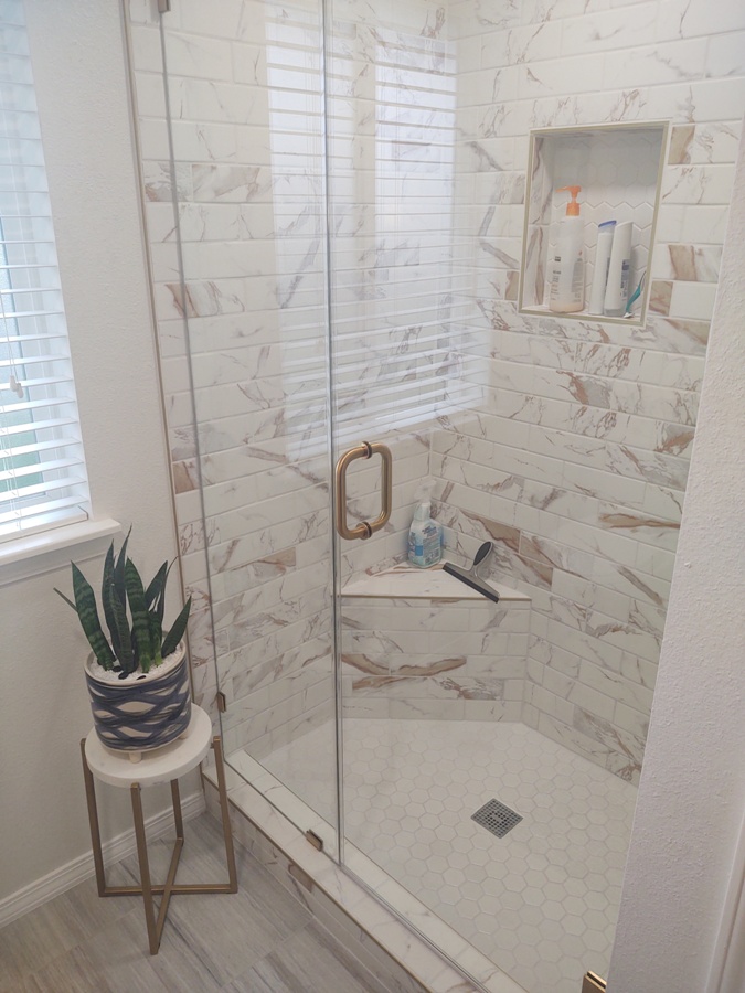 Tile shower with stainless fixtures and rain shower head